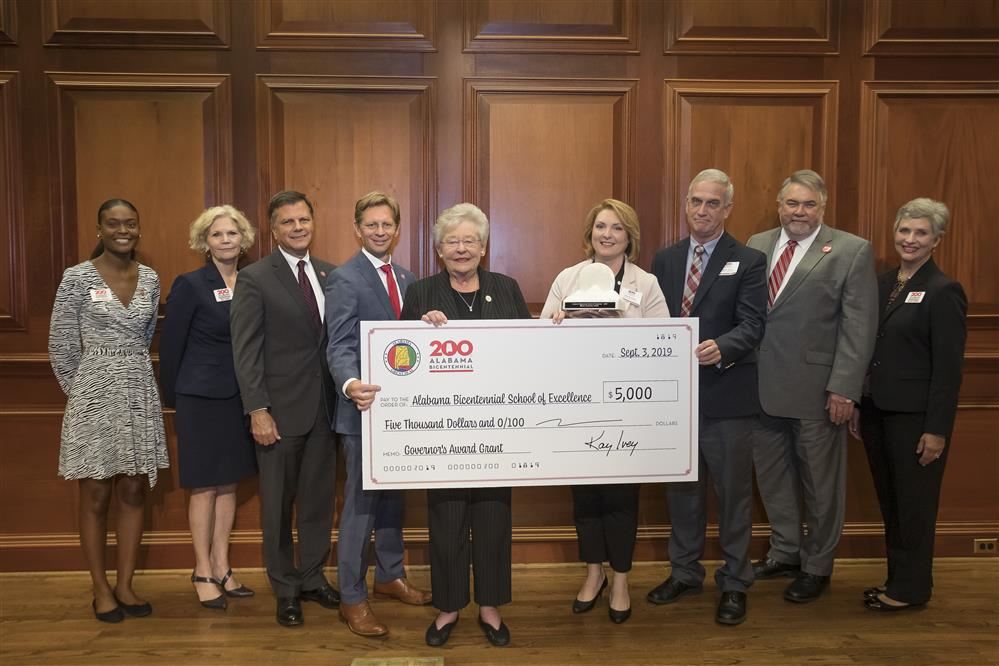 Officials accepting grant with Governor Kay Ivey for Walker Elementary. Officials accepting grant with Governor Kay Ivey for Walker Elementary.